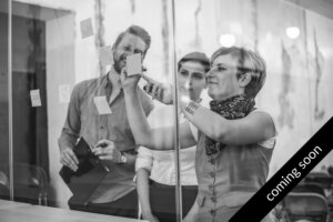 greyed out image of three professionals with a banner over the bottom right corner with the text 'coming soon'